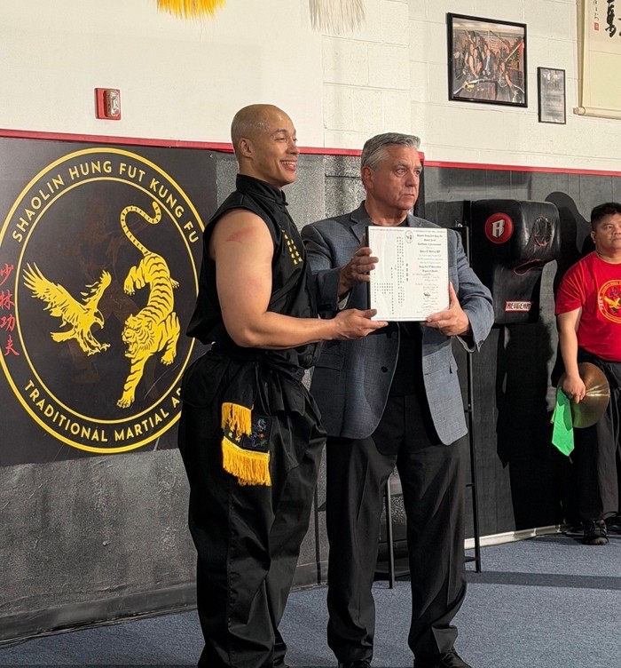 Master James E. Whitley III receiving his Hung Fut 9th Generation Degree of Master certificate