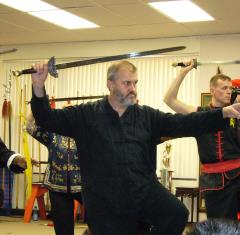 Student holding a Tai Chi straight-sword form